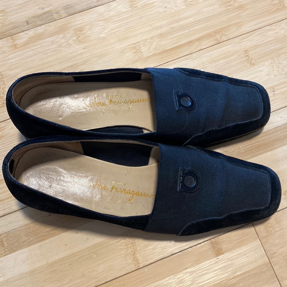 Black Ferragamo loafer with logo on top. Size 6